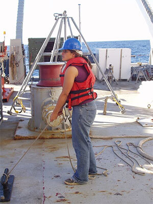 Photo of Sindia Sosdian collecting a sediment core on research cruise during her Ph.D. studies.