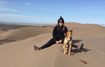 Photo of Emily Pumphrey Pearson with dog Murray in Sand Dunes National Park