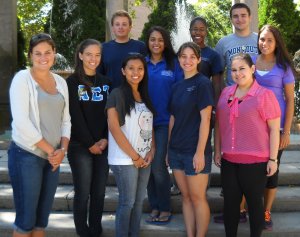 Group photo of Monmouth University students standing at the fountains in Erlanger Gardens