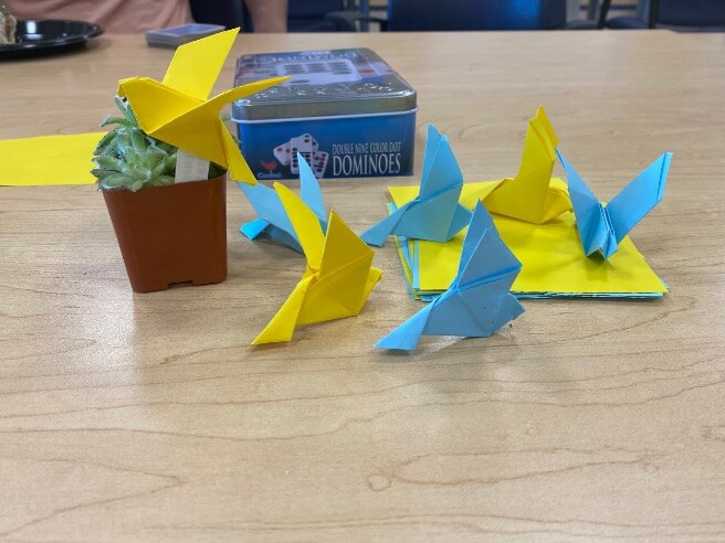 Six origami birds on a table.