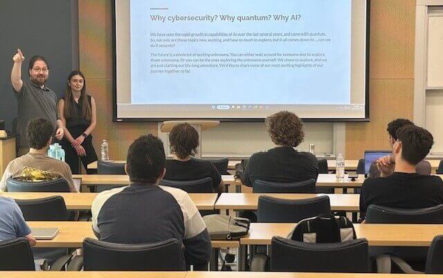 Students look on in classroom as man and women speak about cybersecurity, AI, and quantum.