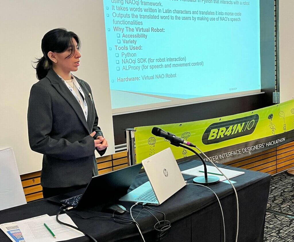 Woman in suit presenting at a conference.
