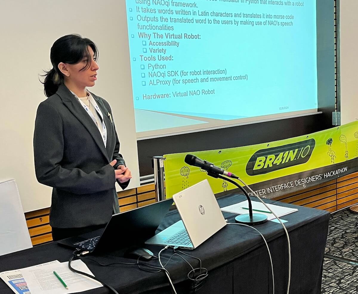 Woman in suit presenting at a conference.