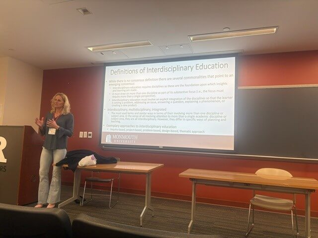 Presentation in classroom, slide titled "Definitions of Interdisciplinary Education"