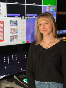 Gianna Olsen standing in front of video editing equipment