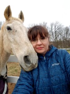 Dororthy Cleary and a horse nuzzling her cheek