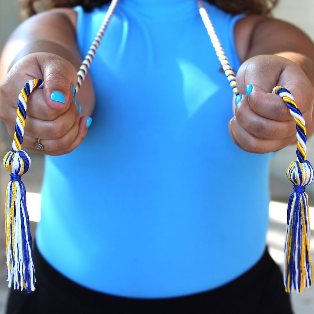 Woman holding honor cords to camera. Follow the link to purchase an honor cord.