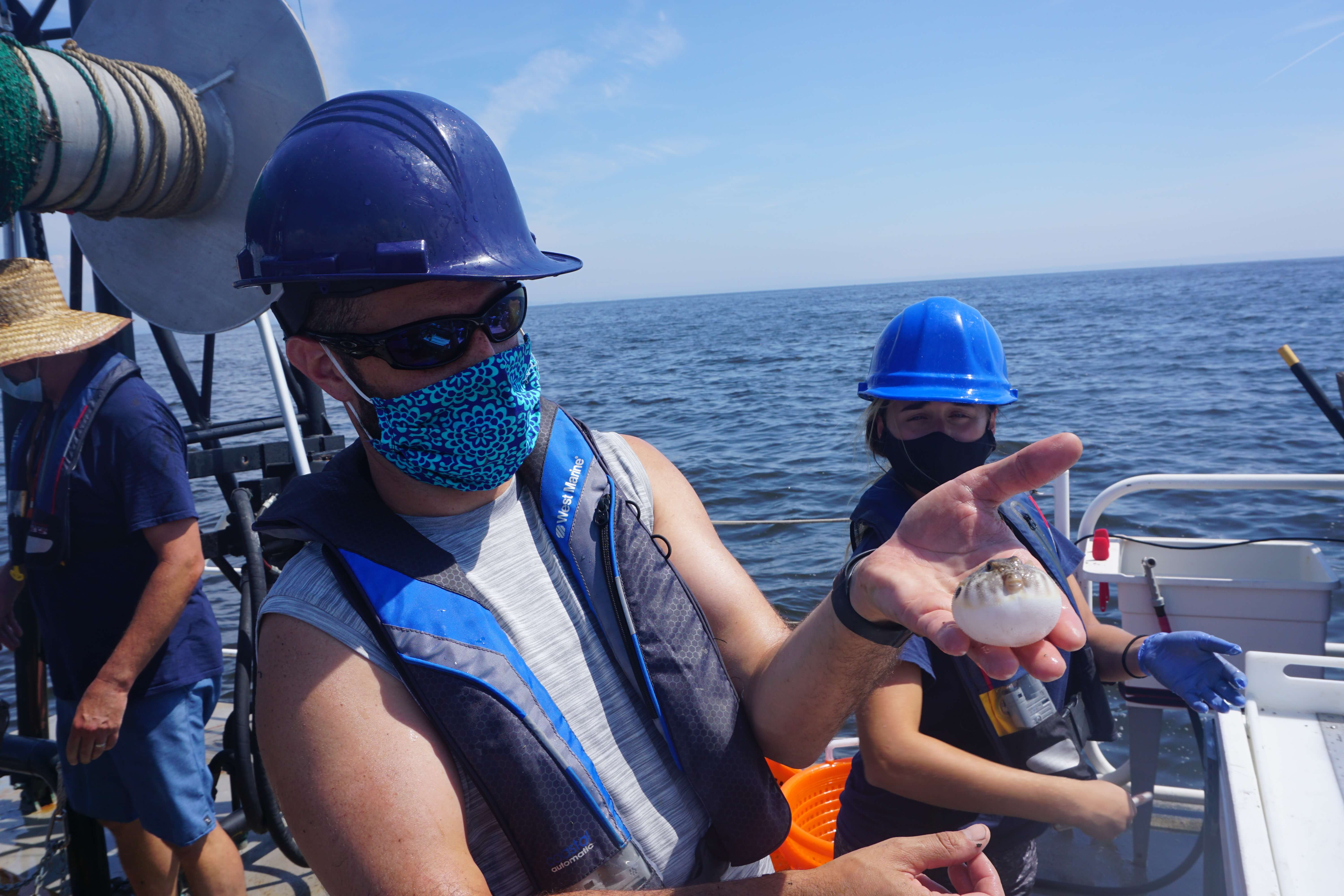 Photo of research team in boat on the water