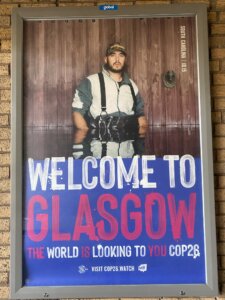 Dramatic image of man up to his hips in flood waters: Welcome to Glasgow