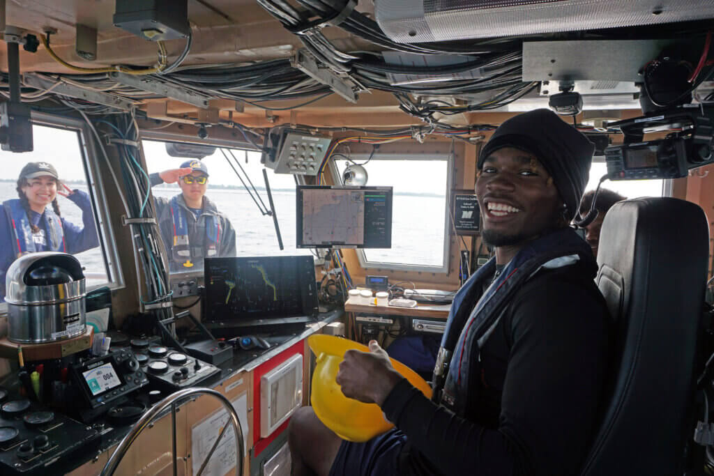 Student in the wheelhouse of the R/V Heidi Lynn Sculthorpe.