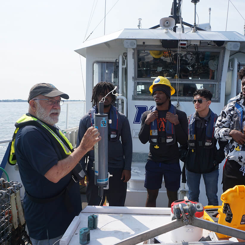 Nickels teaches students about scientific equipment aboard Monmouth's R/V Heidi Lynn Sculthorpe during a 2023 NOAA INFISH program cruise.