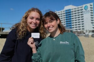 Students holding a gift card