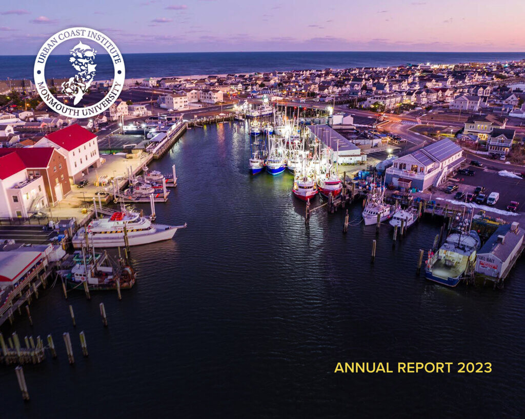 Cover of the Urban Coast Institute 2023 Annual Report, showing an aerial view of a marina at sunset. 