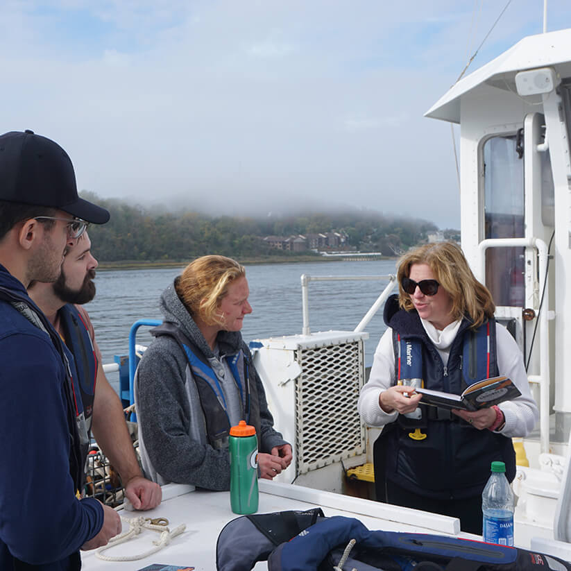 Professor Delaney teach students aboard a vessel