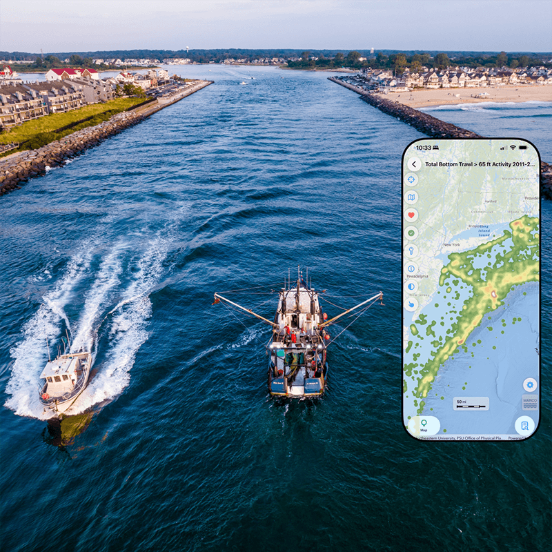 An aerial image of two boats passing through an inlet with an illustration of a map on a phone screen overlaid.