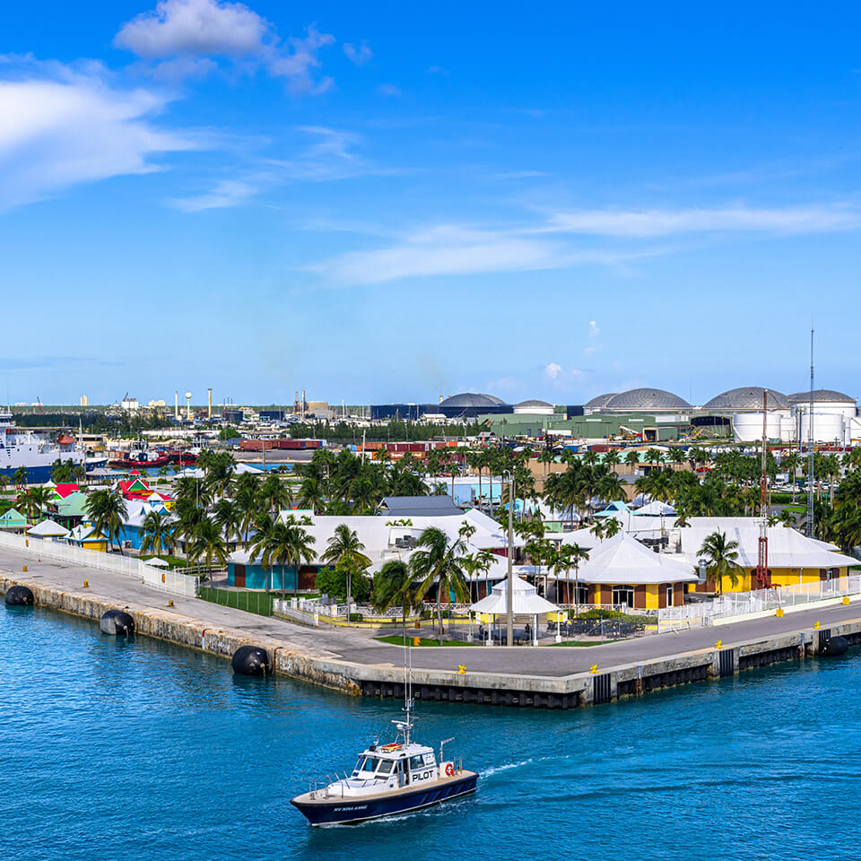 An aerial image of a densely developed waterfront community in the Bahamas